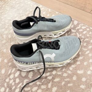 ON Running Cloudmonster athletic shoes.